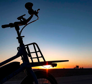 Handlebars and front platform of the CERO One bike with a sunset in the background