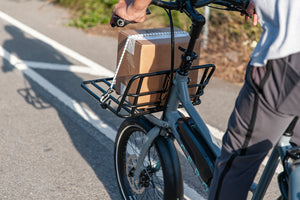 Gray CERO One bike with a front platform carrying a cardboard box