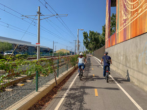 Two riders biking down the Expo bike path in Los Angeles during a test ride.