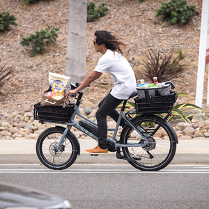 Rider carrying groceries on a CERO One bike with a Small Basket in the front and rear